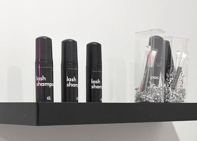 Lash care products on display at Lashes by Rina, Calgary, Alberta, CA. Enhance your beauty routine.