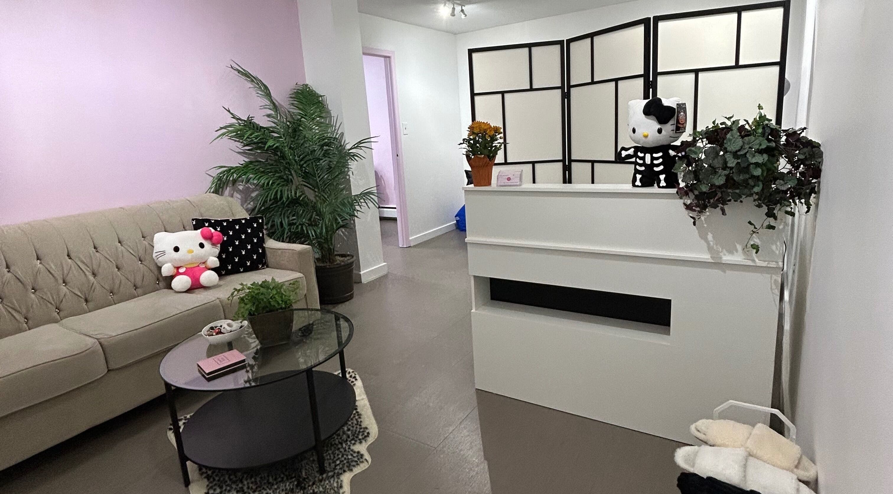 Inviting and cozy lobby at Lashes by Rina in Calgary, Alberta, CA with plush seating and charming decor.