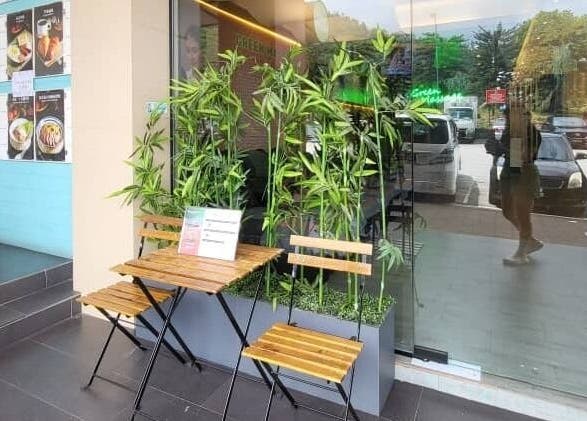 Charming outdoor seating at Green Massage, Genting Highlands, Pahang, MY with lush bamboo plants.