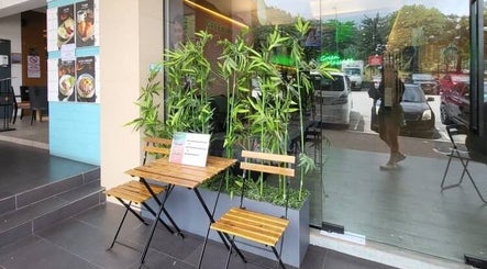 Charming outdoor seating at Green Massage, Genting Highlands, Pahang, MY with lush bamboo plants.