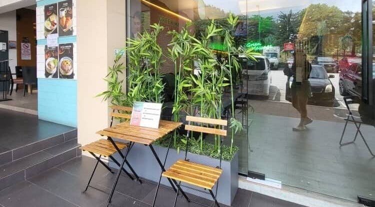 Charming outdoor seating at Green Massage, Genting Highlands, Pahang, MY with lush bamboo plants.