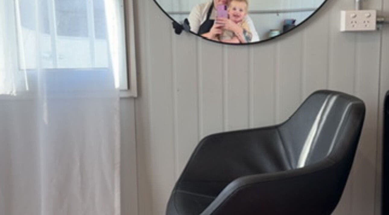 Elegant black chair by a mirror at K Rose & Co, Allens Rivulet, Tasmania, AU. Bright, cozy interior.