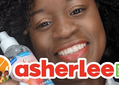 Smiling person using Asherlee Naturals product in Kingston, St. Andrew Parish, JM. Vibrant curls highlighted.