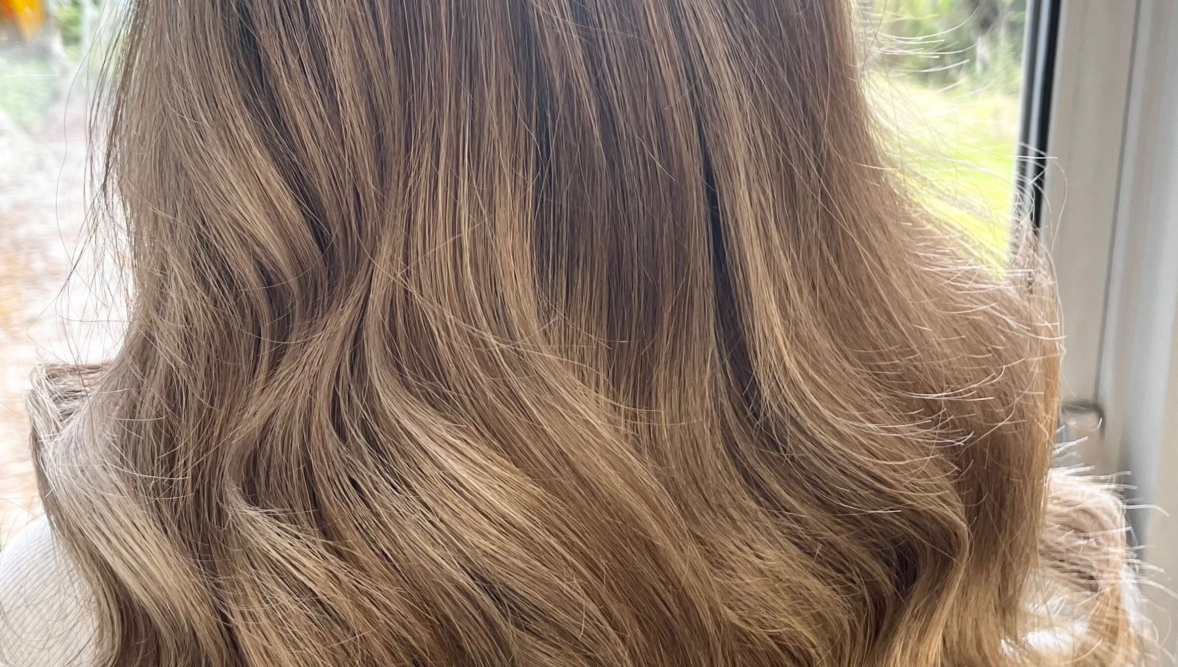 Golden blonde hair styled in soft waves at Hair by Lisa Abel in Port Elphinstone, Scotland, GB.