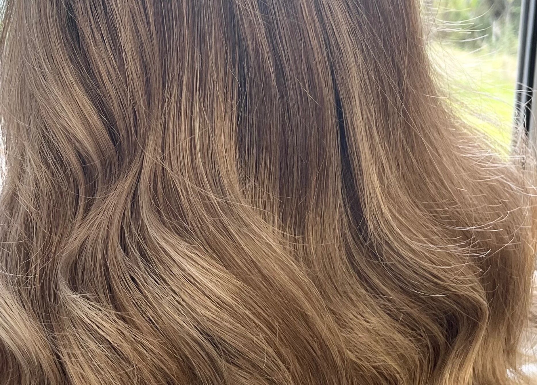 Golden blonde hair styled in soft waves at Hair by Lisa Abel in Port Elphinstone, Scotland, GB.