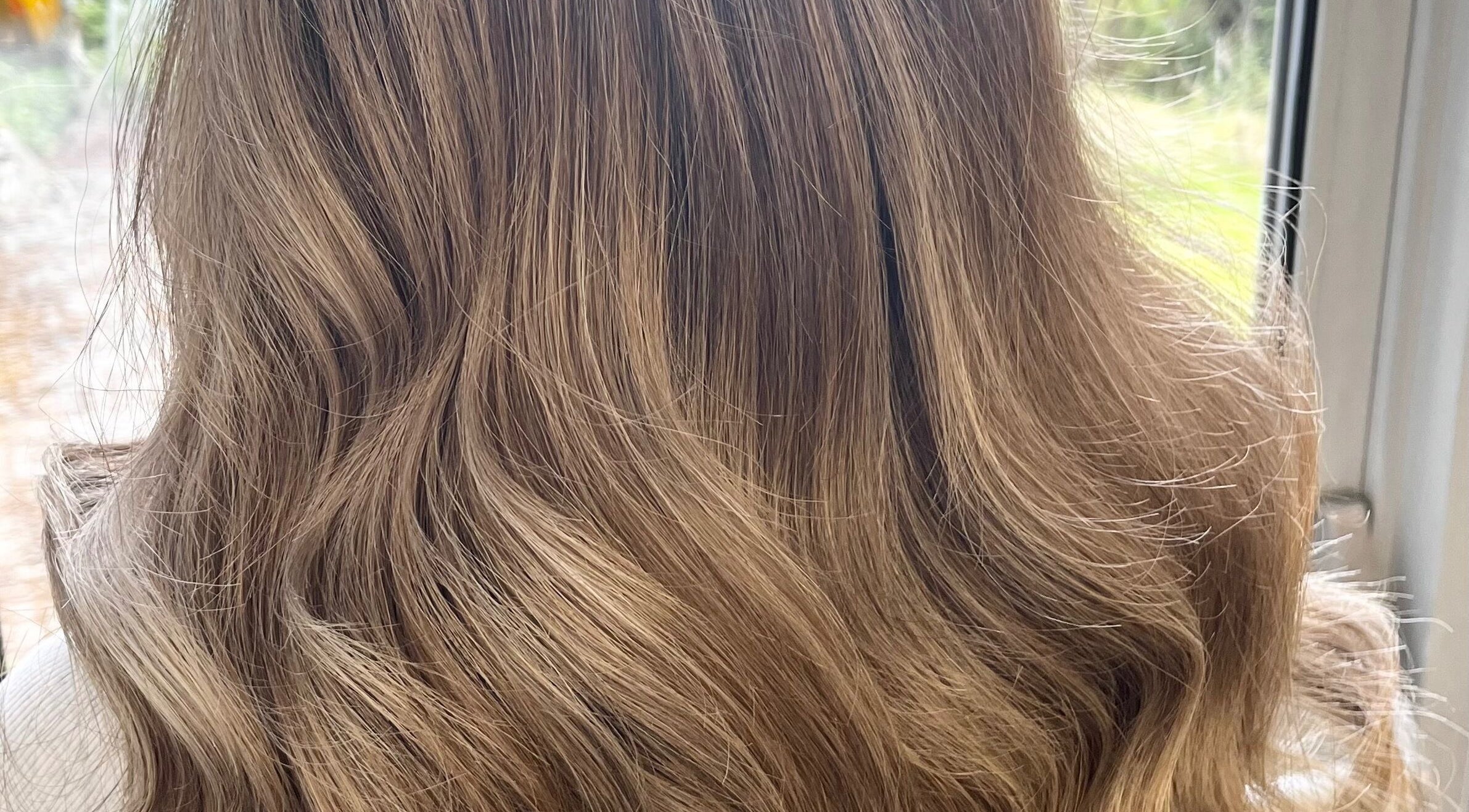 Golden blonde hair styled in soft waves at Hair by Lisa Abel in Port Elphinstone, Scotland, GB.