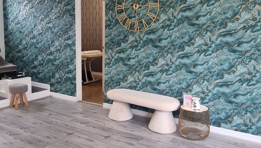 Modern lounge with teal marble wall, bench, and massage room at Krisu in Wolverhampton, England, GB.