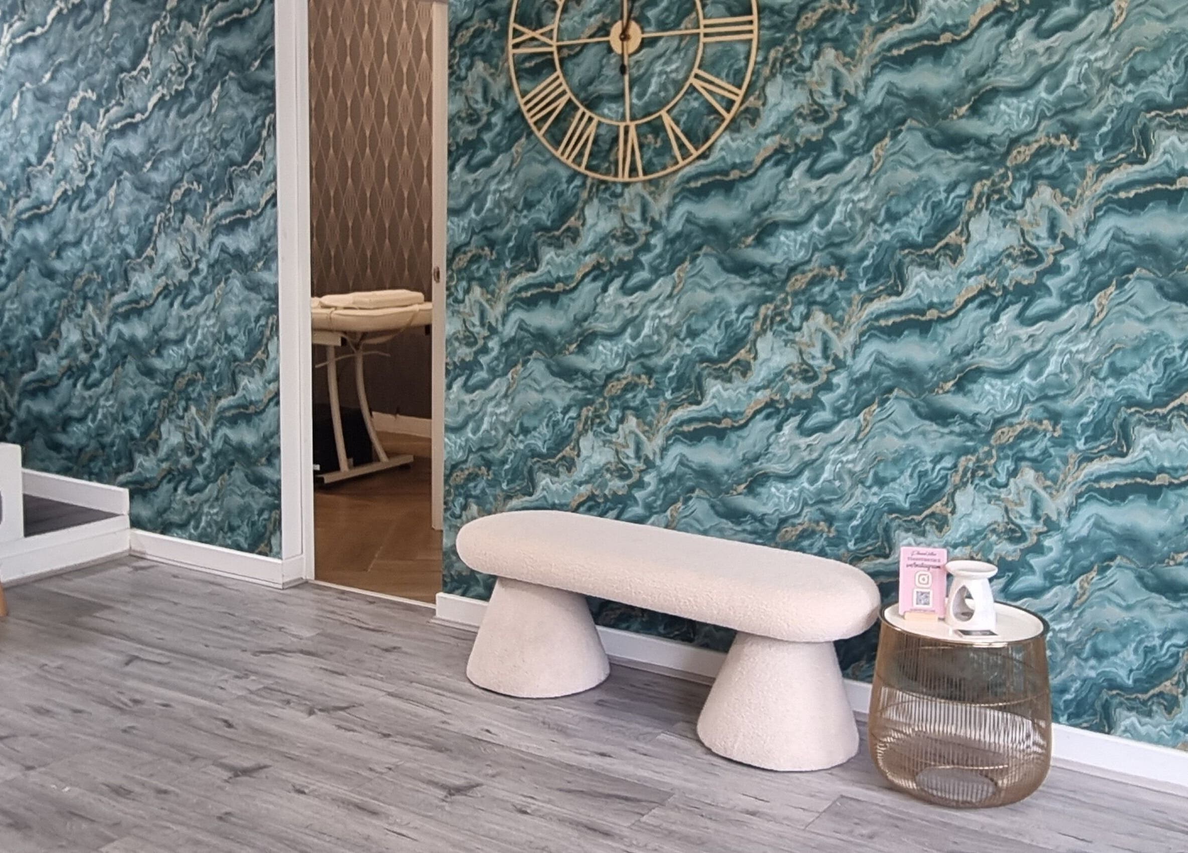 Modern lounge with teal marble wall, bench, and massage room at Krisu in Wolverhampton, England, GB.