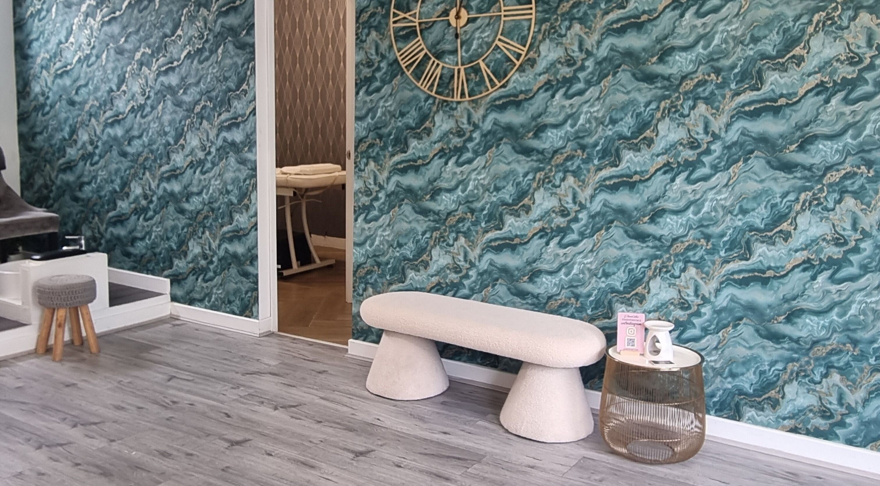 Modern lounge with teal marble wall, bench, and massage room at Krisu in Wolverhampton, England, GB.