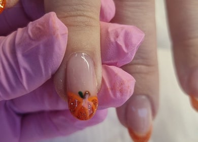 Orange nail art at Krisu, Wolverhampton, England, GB. Elegant designs with vibrant colors.