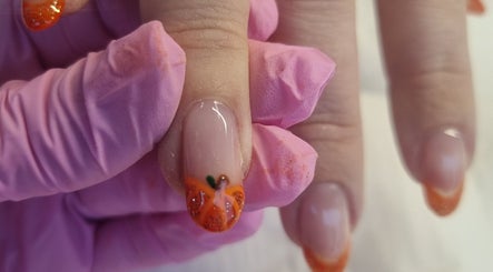 Orange nail art at Krisu, Wolverhampton, England, GB. Elegant designs with vibrant colors.