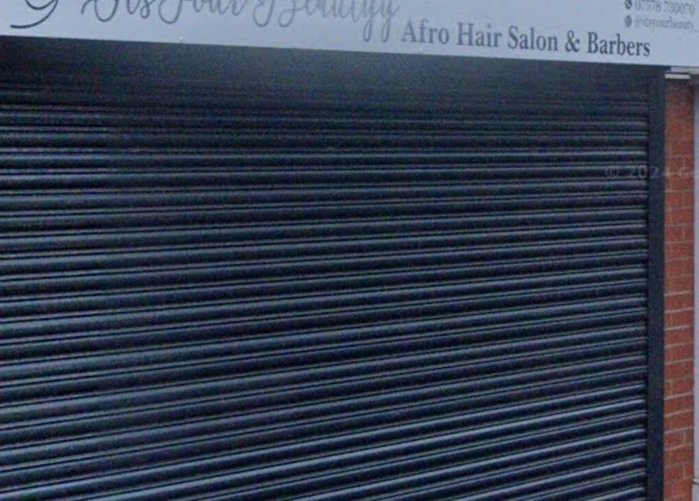 Closed shutters at 28 higher bridge street, Bolton, England, GB for It’s Your Beauty salon.