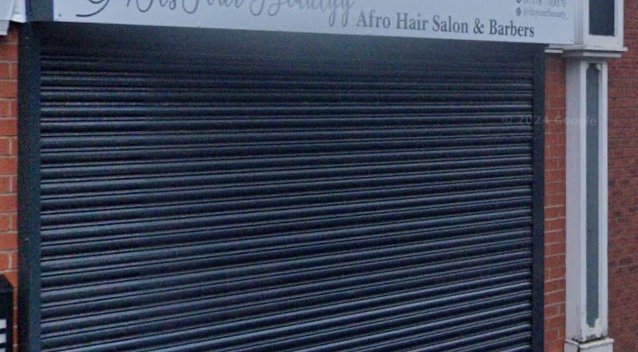 Closed shutters at 28 higher bridge street, Bolton, England, GB for It’s Your Beauty salon.