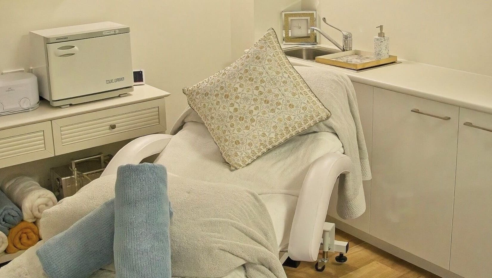 Cozy spa bed in AskinCo at Mooloolaba, Queensland, AU with plush towels and a soft pillow.