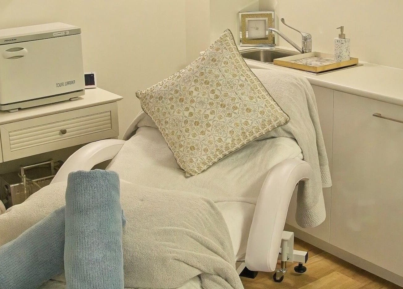 Cozy spa bed in AskinCo at Mooloolaba, Queensland, AU with plush towels and a soft pillow.