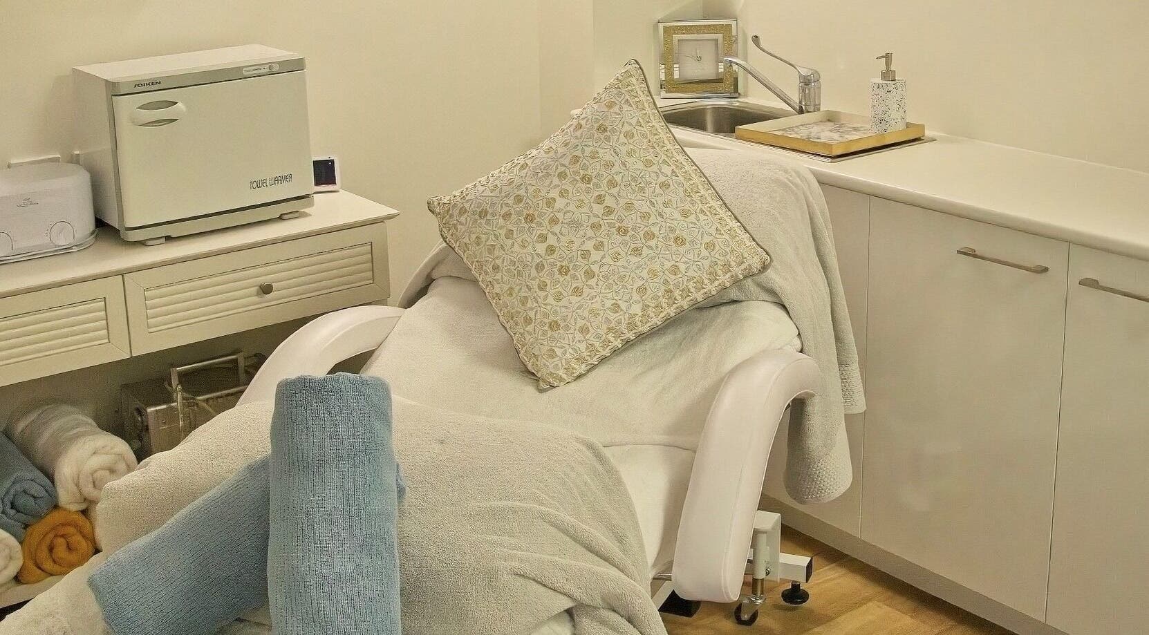 Cozy spa bed in AskinCo at Mooloolaba, Queensland, AU with plush towels and a soft pillow.