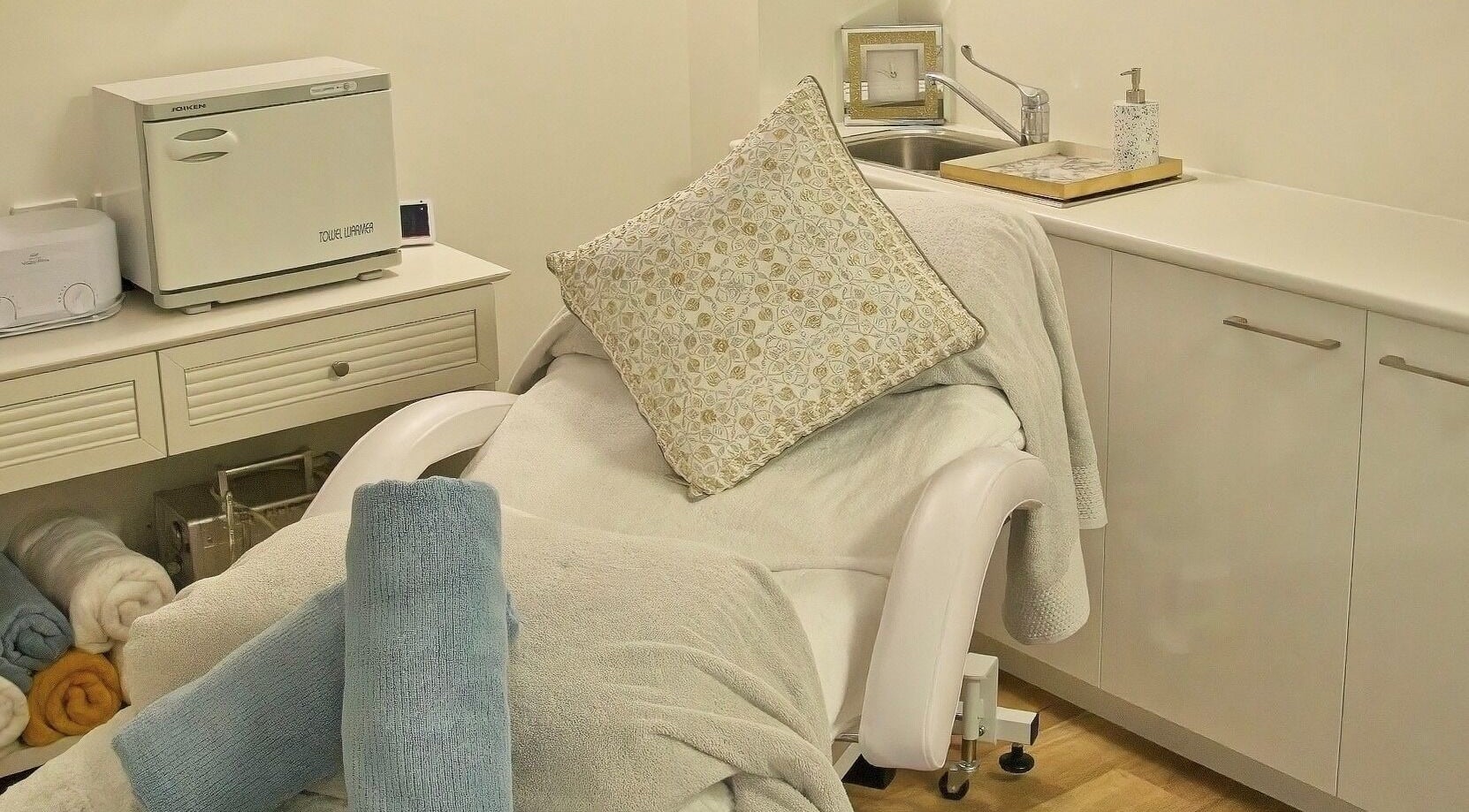 Cozy spa bed in AskinCo at Mooloolaba, Queensland, AU with plush towels and a soft pillow.