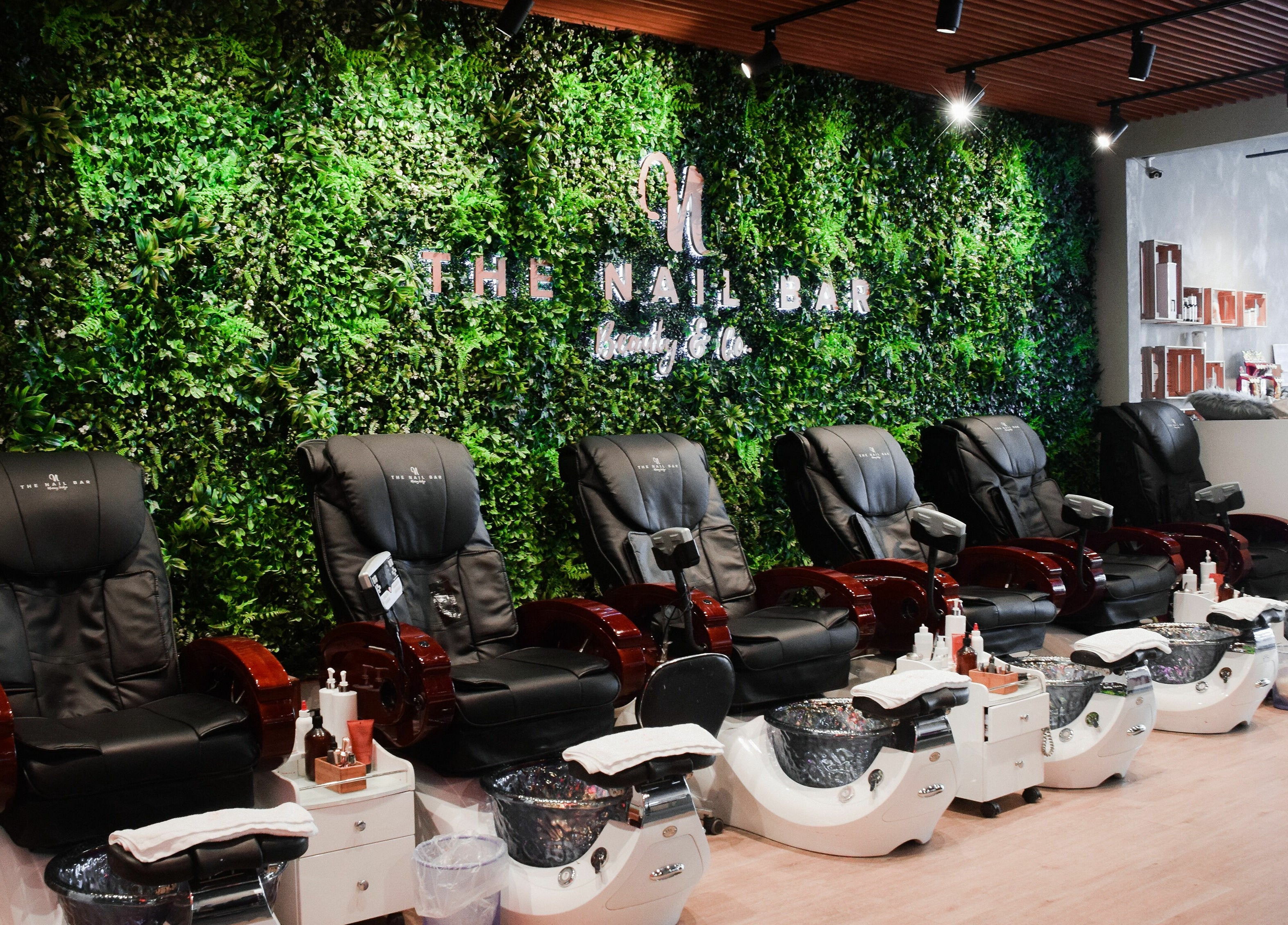 Pedicure chairs at The Nail Bar Murray Bridge, vibrant greenery wall in Murray Bridge, South Australia, AU.