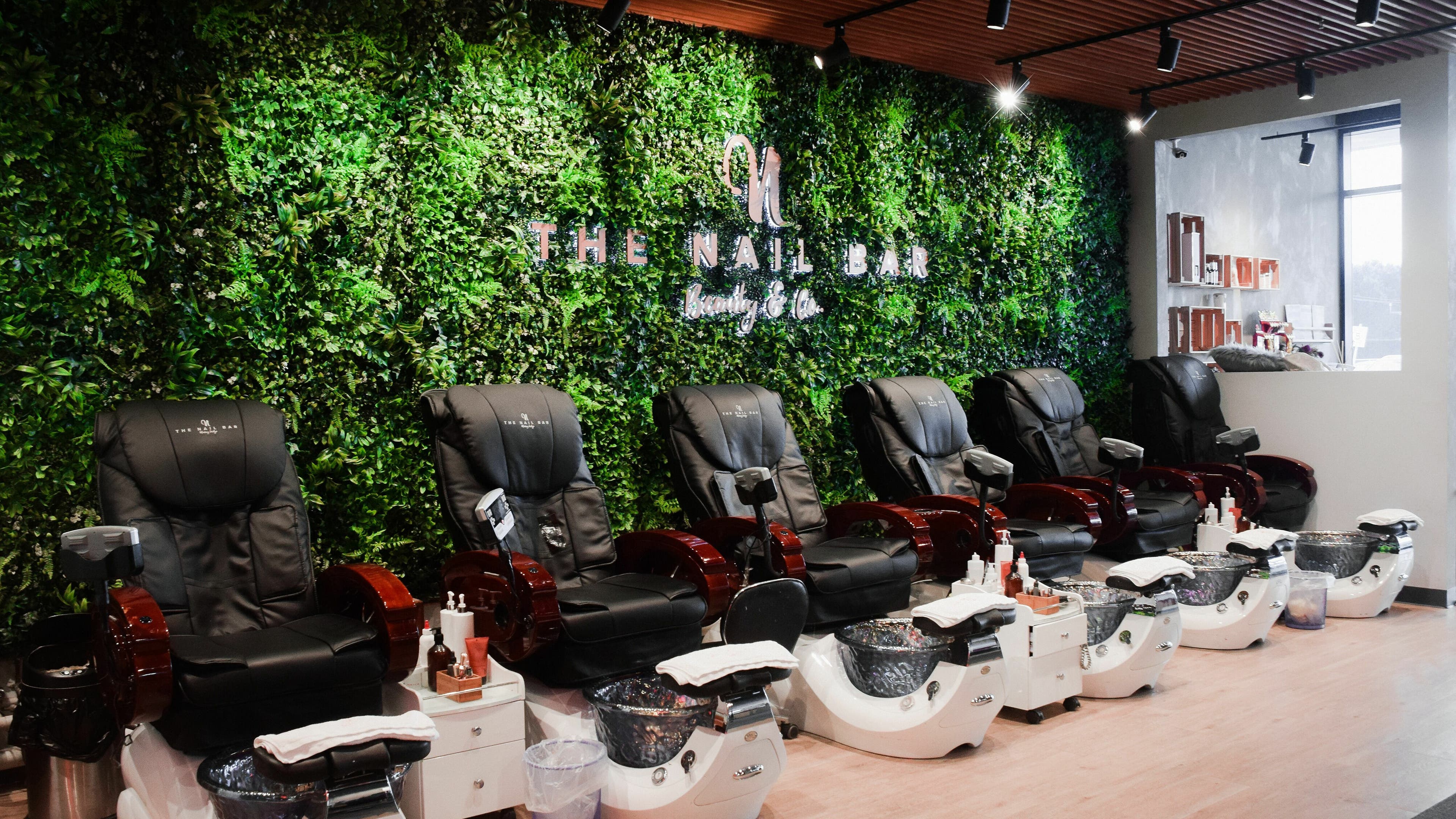 Pedicure chairs at The Nail Bar Murray Bridge, vibrant greenery wall in Murray Bridge, South Australia, AU.