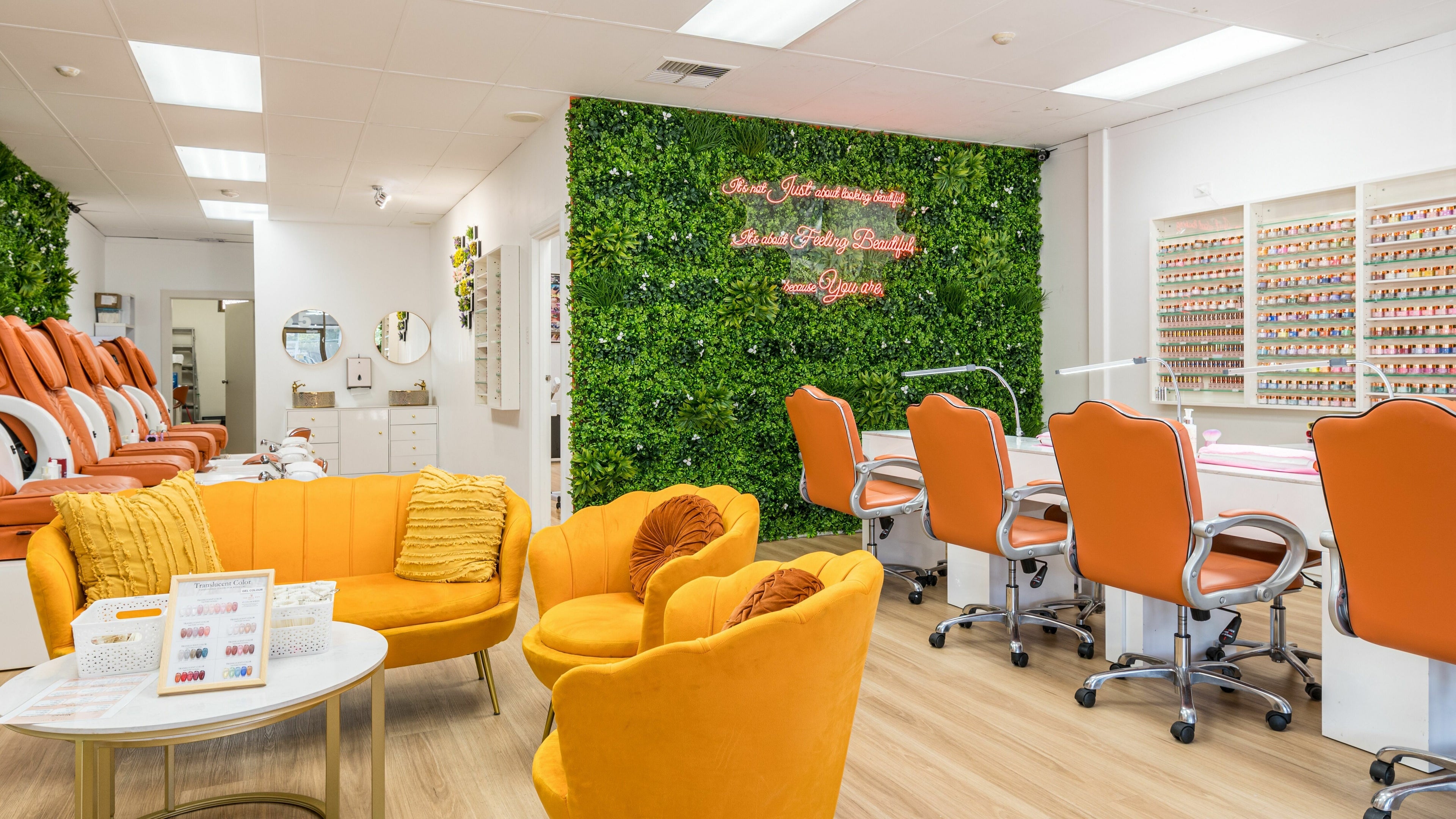 Bright interiors of The Nail Bar Chinatown in Adelaide, South Australia, AU, featuring bold orange seating.