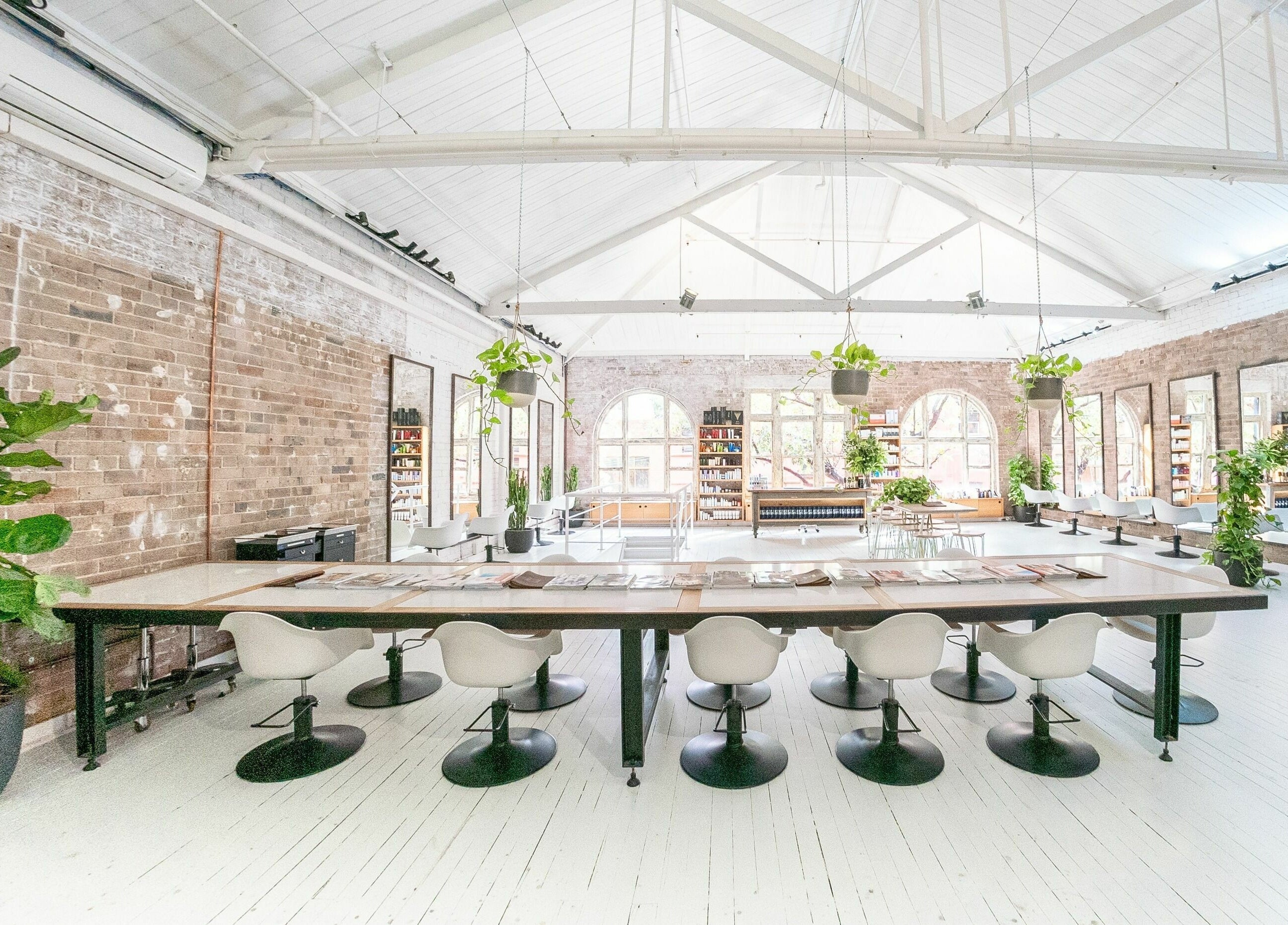 Chic interior of E+Co - Kippax Street, Surry Hills, New South Wales, AU featuring modern decor and greenery.