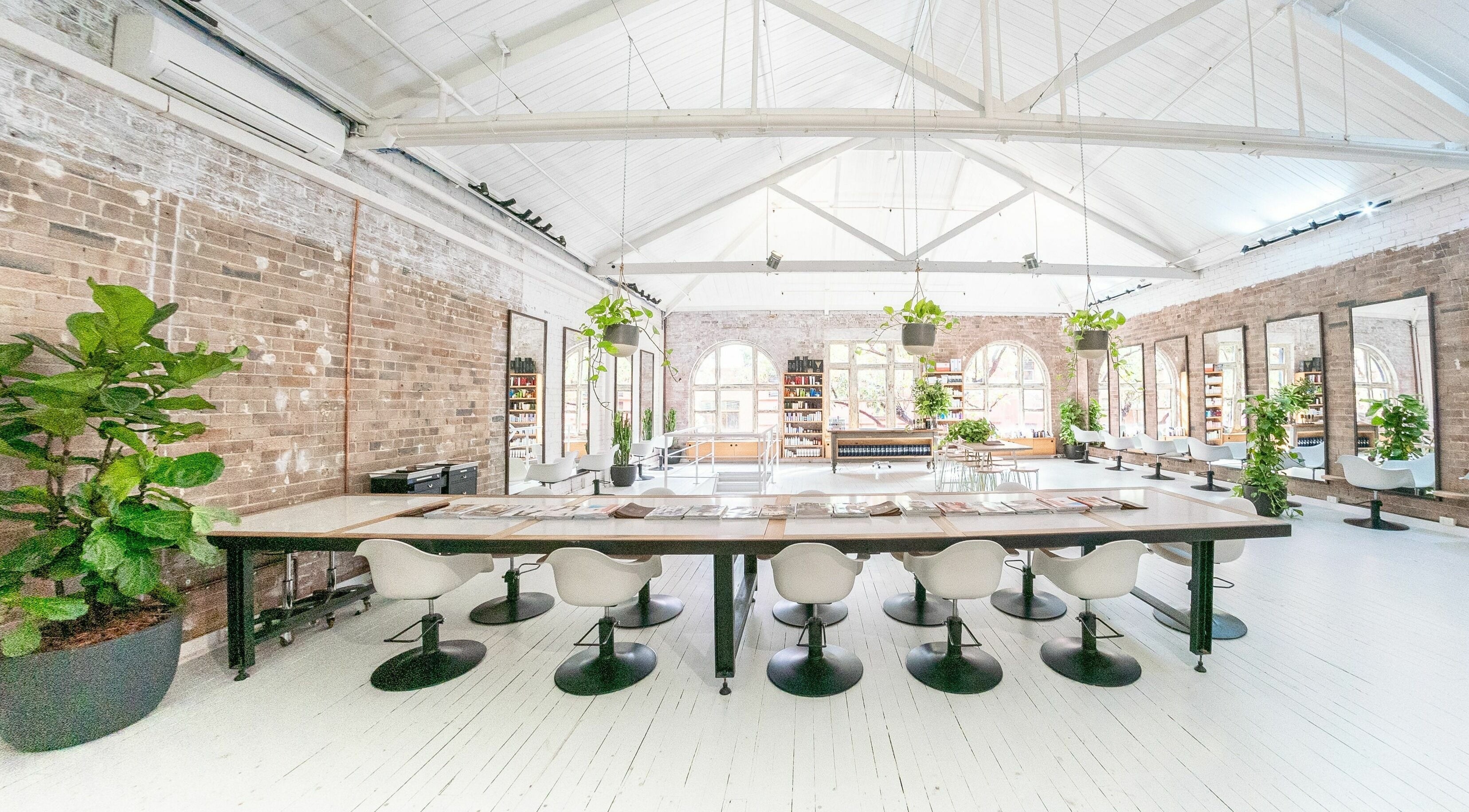 Chic interior of E+Co - Kippax Street, Surry Hills, New South Wales, AU featuring modern decor and greenery.