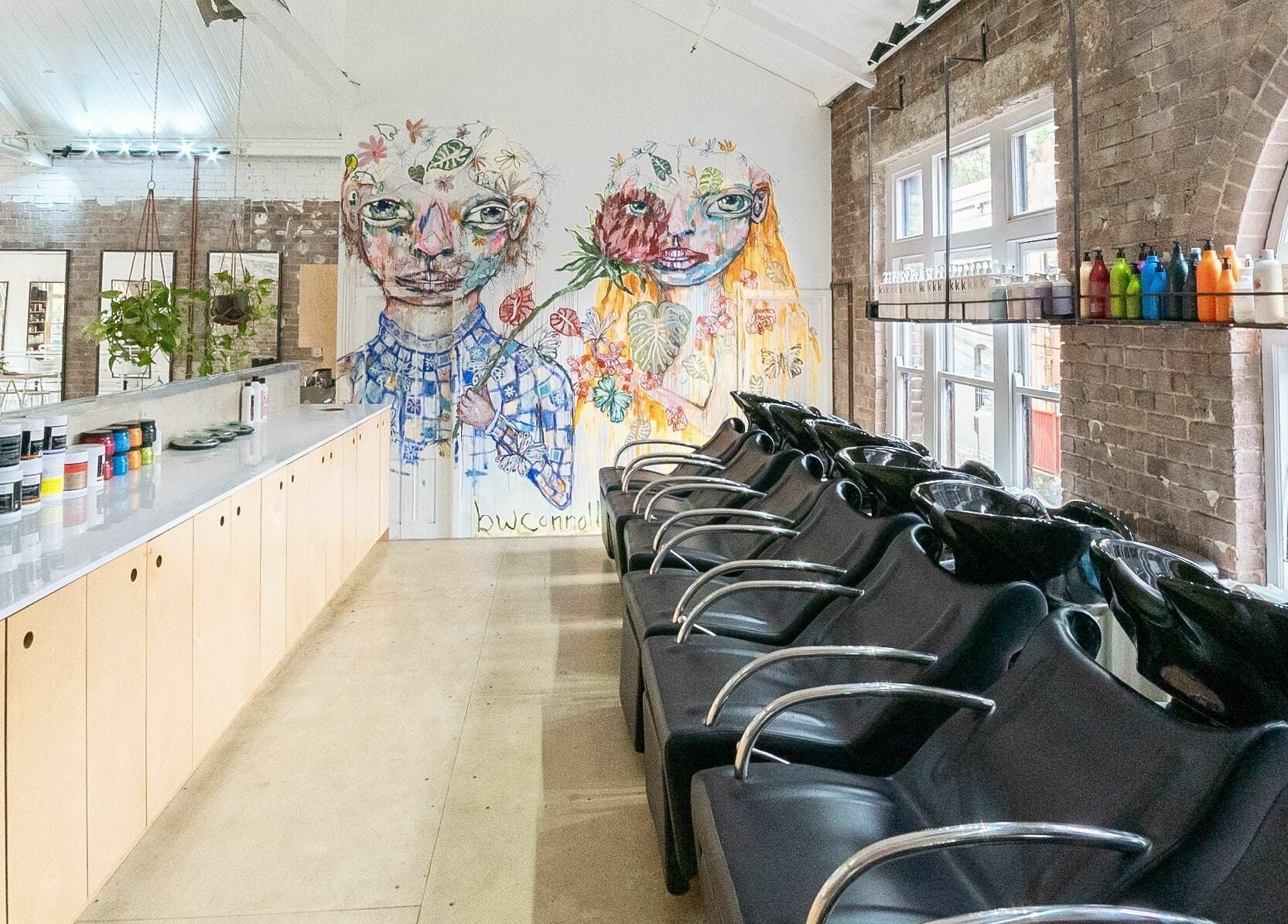 Stylish salon interior at E+Co - Kippax Street in Surry Hills, New South Wales, AU with vibrant mural art.