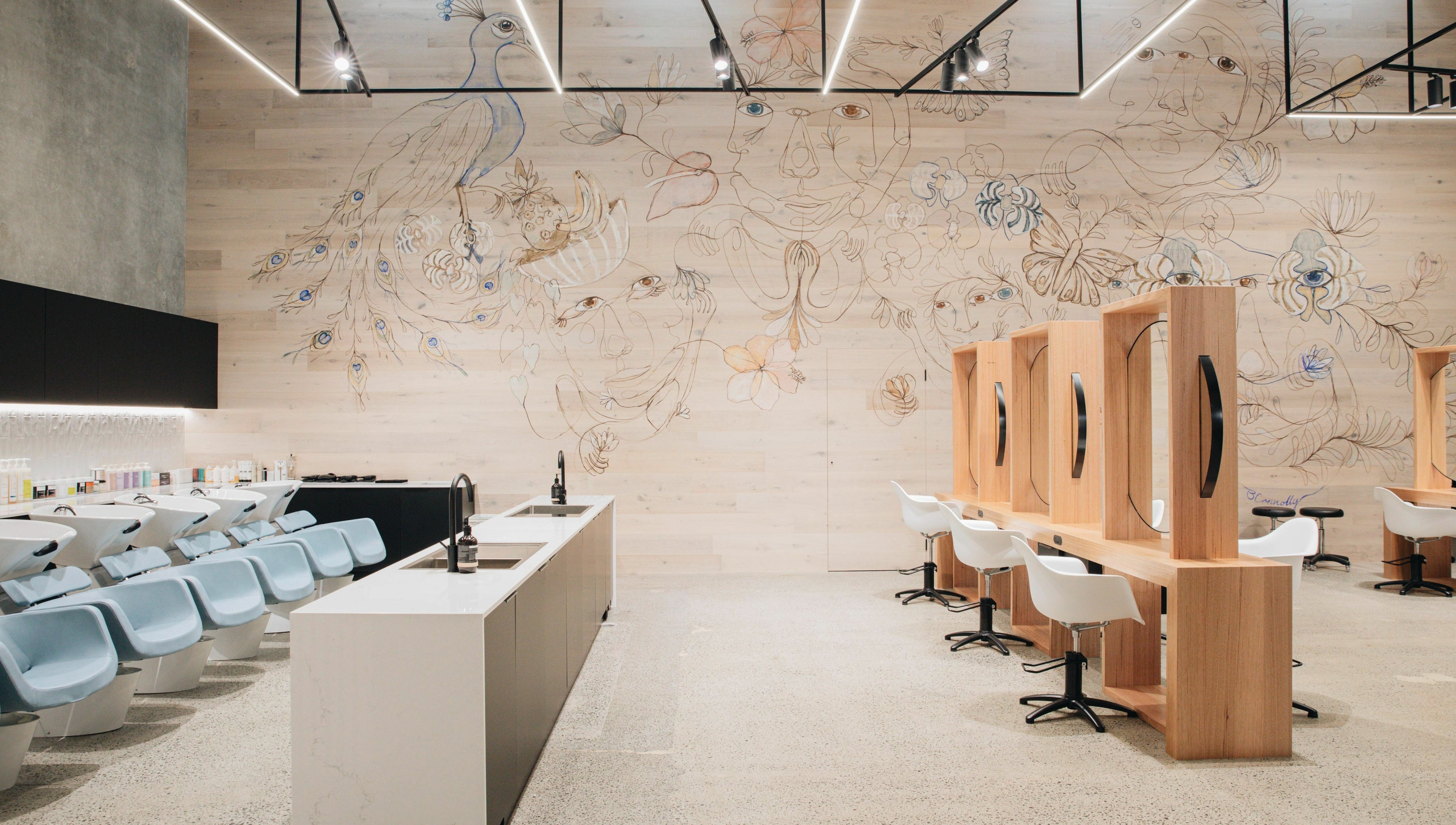 Stylish salon interior with peacock mural at E+Co - Fortitude Valley in Fortitude Valley, Queensland, AU.