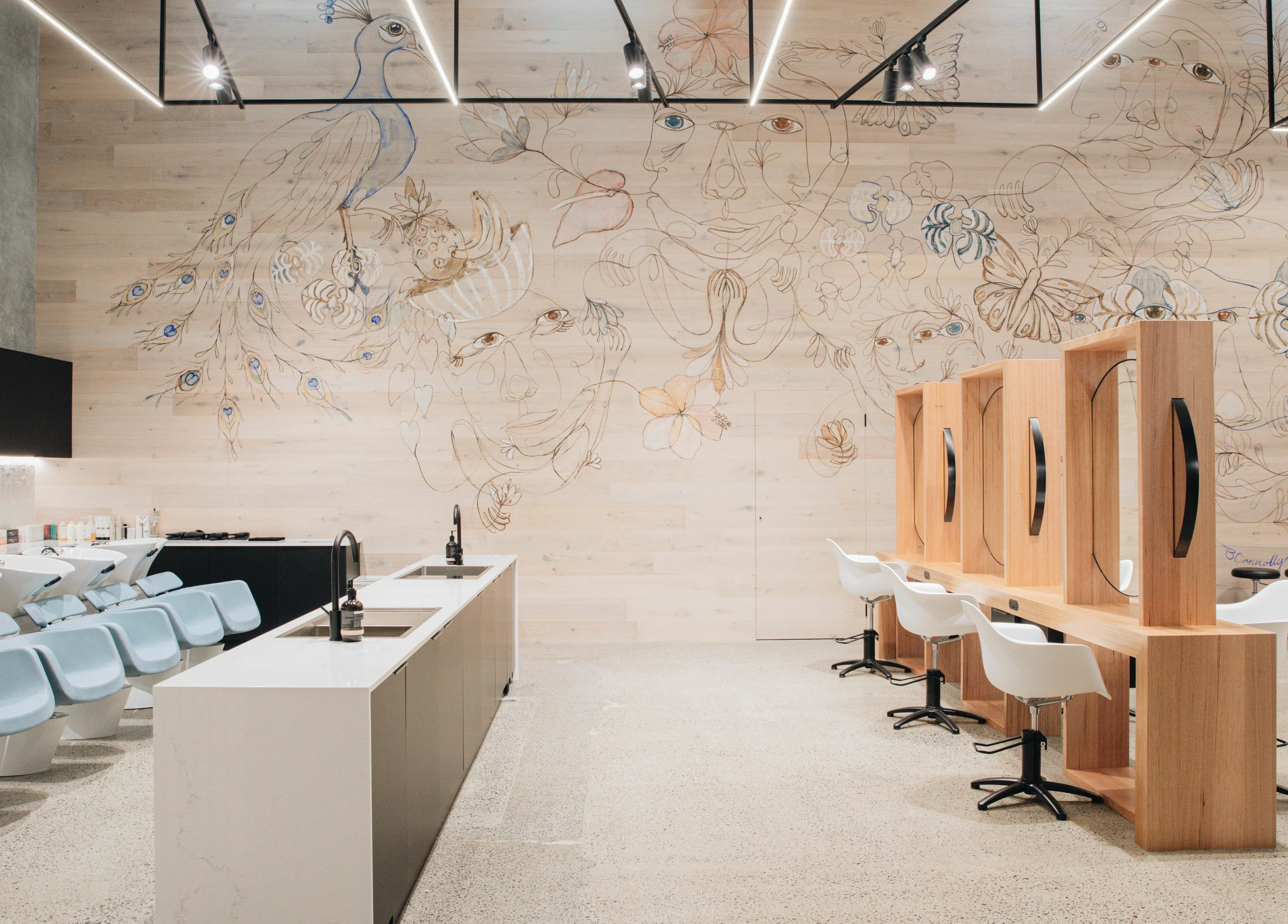 Stylish salon interior with peacock mural at E+Co - Fortitude Valley in Fortitude Valley, Queensland, AU.
