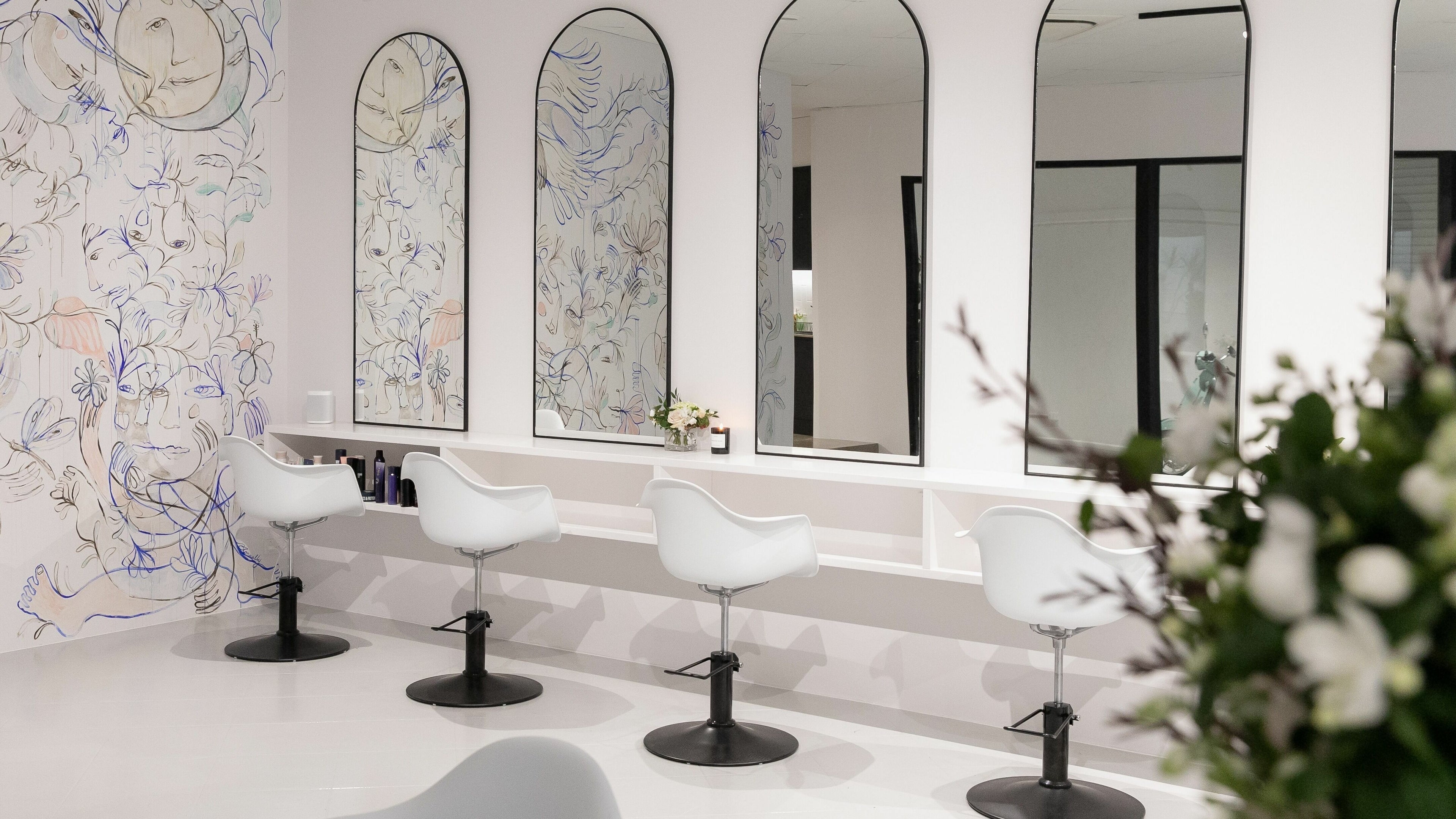 Stylish beauty salon interior at E+Co - Noosa, Noosaville, Queensland, AU with modern chairs and artistic wall decor.