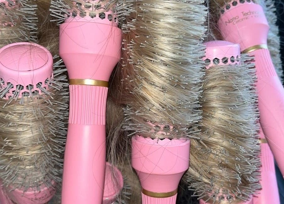 Pink hairbrushes at The Blowdry Bar and Training Academy, Torquay, England, GB, showcasing modern styling tools.