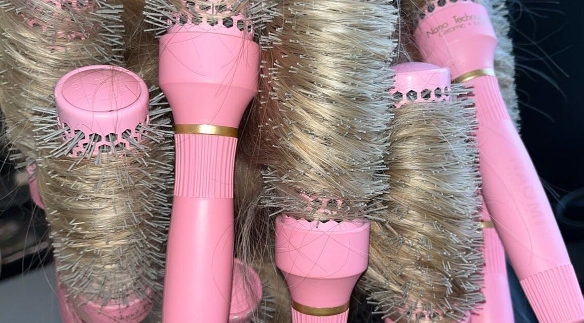 Pink hairbrushes at The Blowdry Bar and Training Academy, Torquay, England, GB, showcasing modern styling tools.