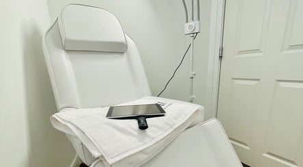 Modern spa chair at Emma Fox Aesthetics, Heybridge, England, GB, ready for treatments with tablet and towel.