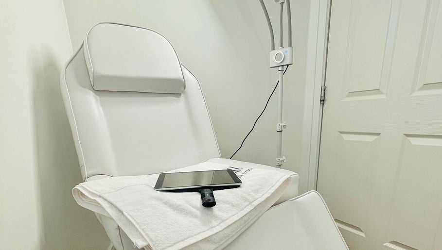 Comfortable treatment chair at Emma Fox Aesthetics in Heybridge, England, GB, with soft towel and tablet.