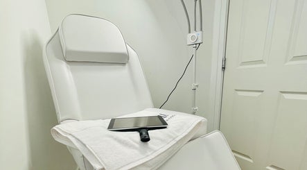 Comfortable treatment chair at Emma Fox Aesthetics in Heybridge, England, GB, with soft towel and tablet.