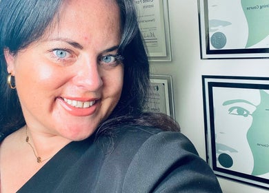 Owner at Emma Fox Aesthetics in Heybridge, England, GB, smiling inside a certification-adorned space.