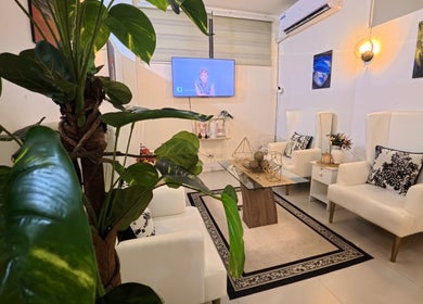 Relaxing seating area at Lueur Beauty and Wellness, Quezon City, Metro Manila, PH, with lush greenery.