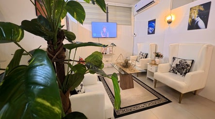 Relaxing seating area at Lueur Beauty and Wellness, Quezon City, Metro Manila, PH, with lush greenery.