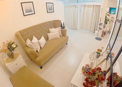 Elegant lounge with plush sofa at Lueur Beauty and Wellness, Quezon City, Metro Manila, PH.