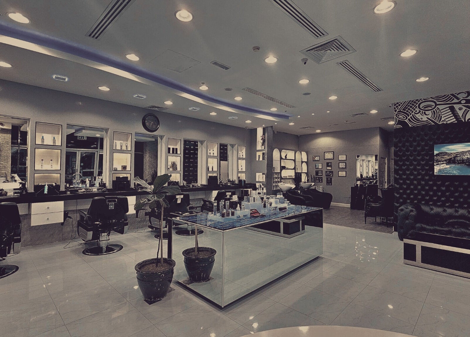 Interior of Comb and Scissors Gents Salon in Dubai, AE, showcasing stylish barber chairs and sleek decor.