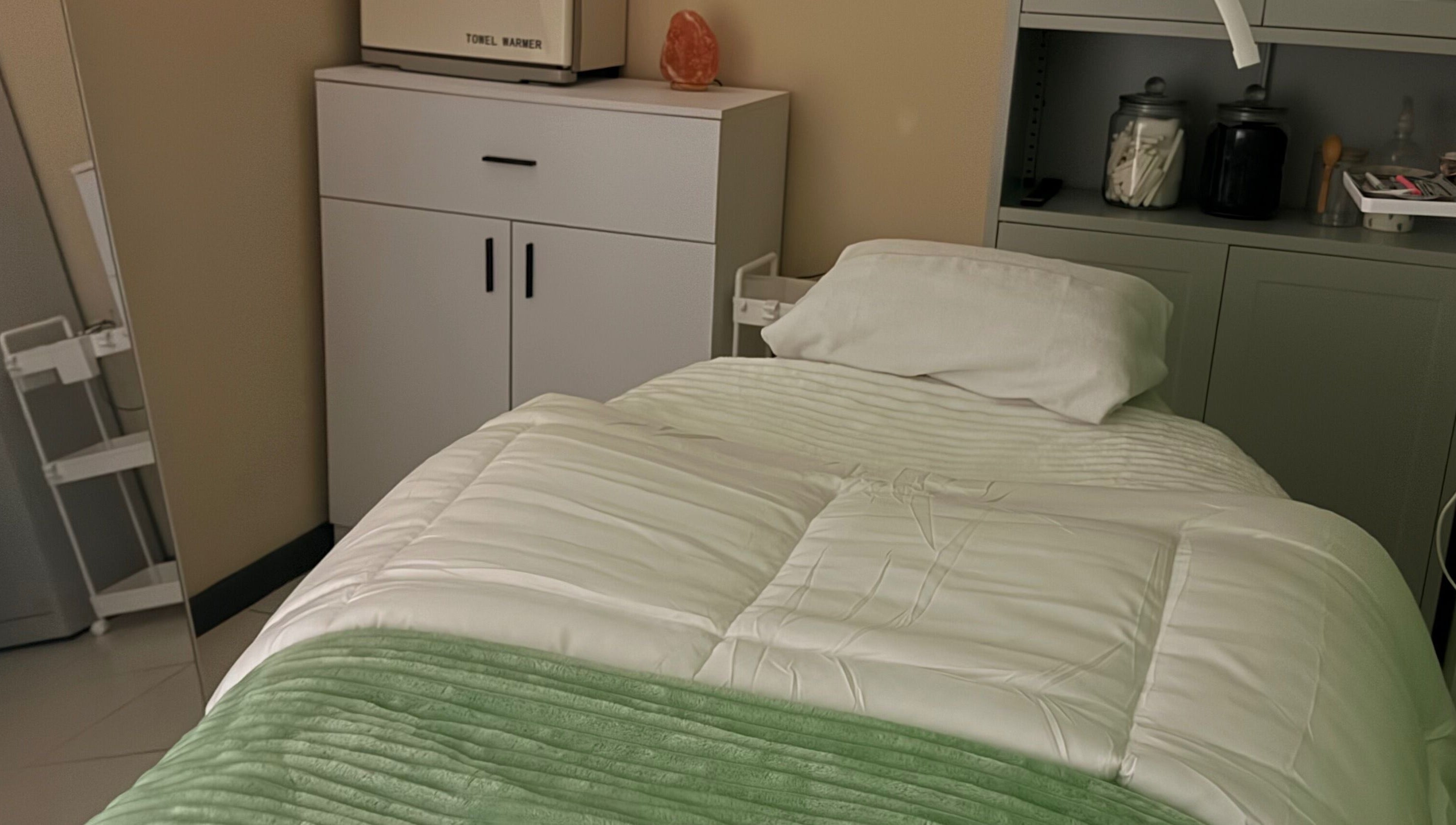 Relaxing spa room at Live Simply Organic Wellness Spa, Kingston, St. Andrew Parish, JM with a cozy treatment bed.