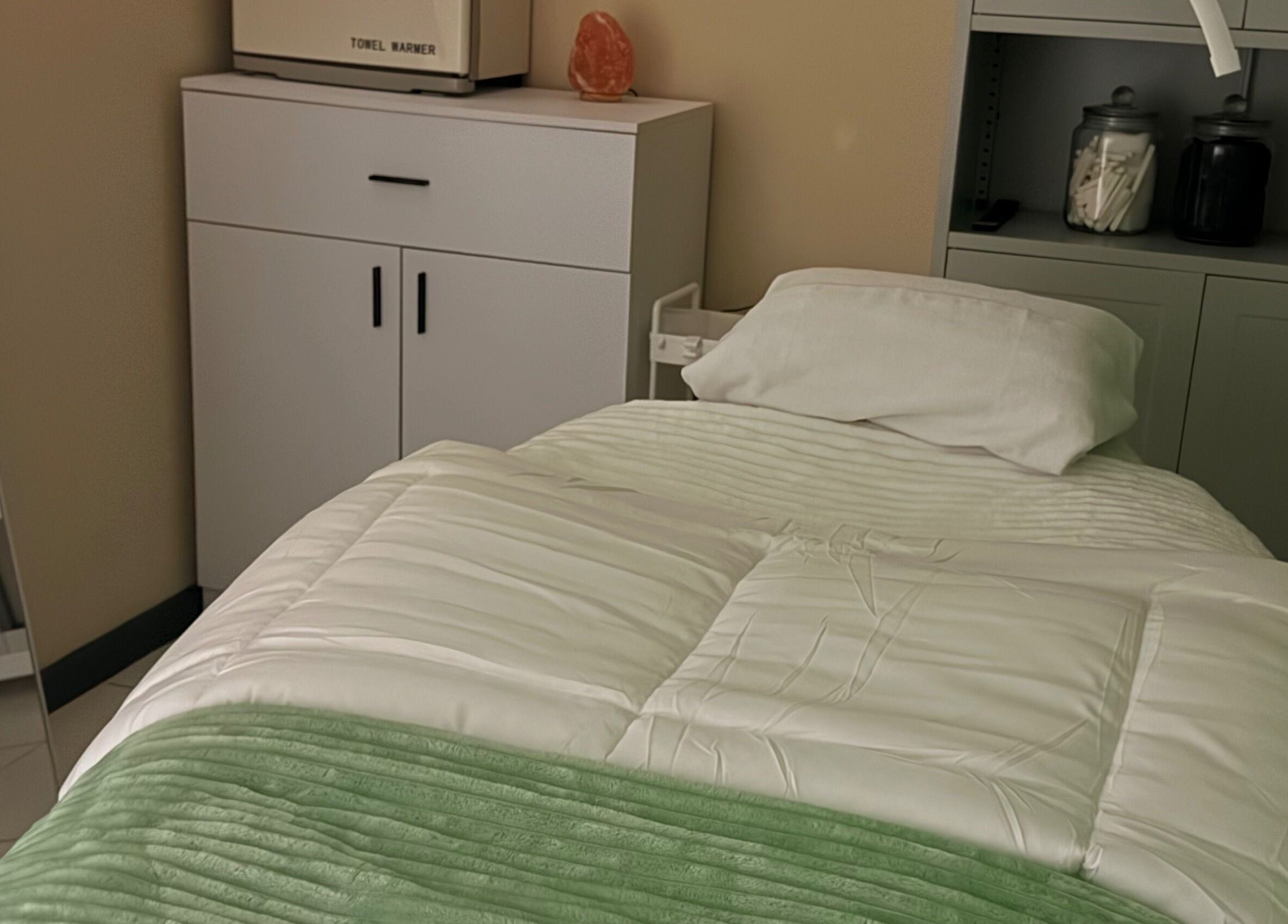 Relaxing spa room at Live Simply Organic Wellness Spa, Kingston, St. Andrew Parish, JM with a cozy treatment bed.