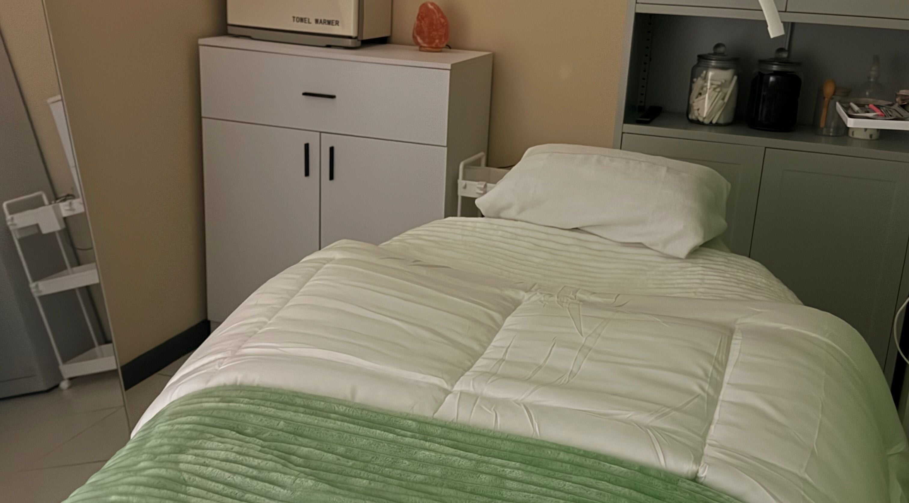 Relaxing spa room at Live Simply Organic Wellness Spa, Kingston, St. Andrew Parish, JM with a cozy treatment bed.