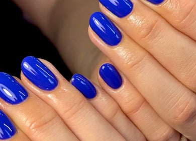 Bright blue manicured nails at Nails by Shan, Cleckheaton, England, GB showcasing expert nail artistry.