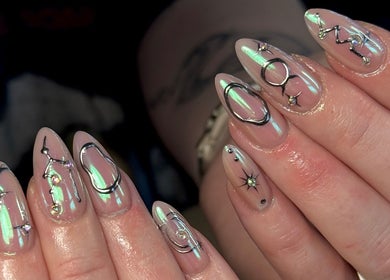 Intricate celestial nail art at Nails by Shan in Cleckheaton, England, GB, showcasing shimmering designs.