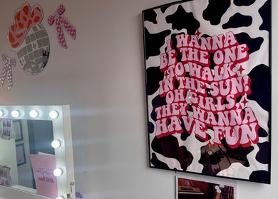 Stylish interior of Nails by Shan in Cleckheaton, England, GB, featuring trendy wall art and illuminated vanity mirror.