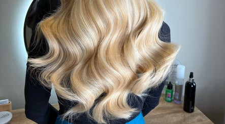 Blonde wavy hair styled at Extensions by Beth, Harrogate, England, GB, showcasing luminous curls.