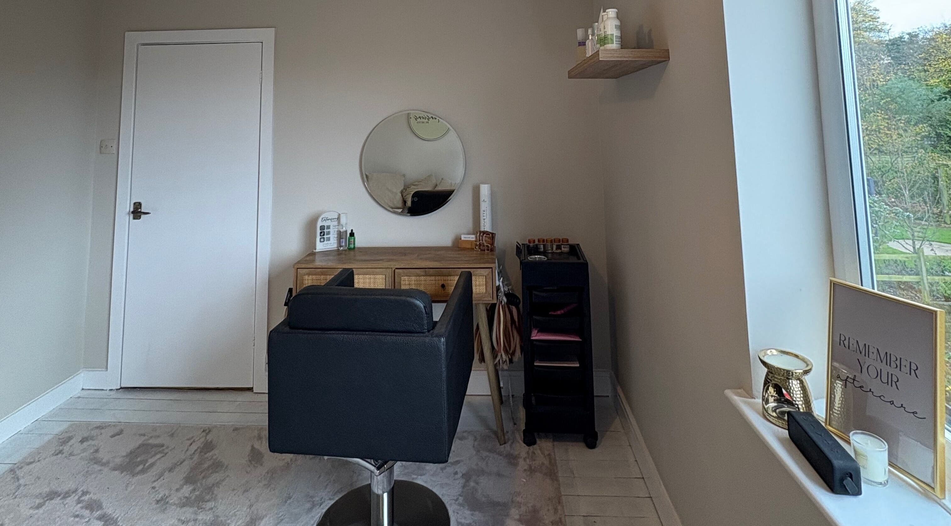 Stylish salon interior at Extensions by Beth in Knaresborough, England, GB. Modern chair and mirror setup.