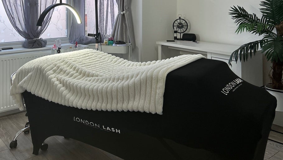 Luxurious treatment room at Libby.J.Beauty, Exmouth, England, GB, featuring a plush massage bed and serene decor.