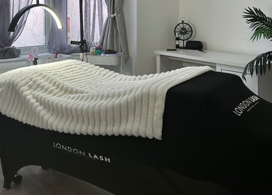 Luxurious treatment room at Libby.J.Beauty, Exmouth, England, GB, featuring a plush massage bed and serene decor.
